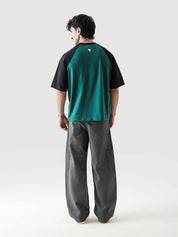 CORE tees racing green raglan male model seated half body lifestyle Pakistan – GROOVY