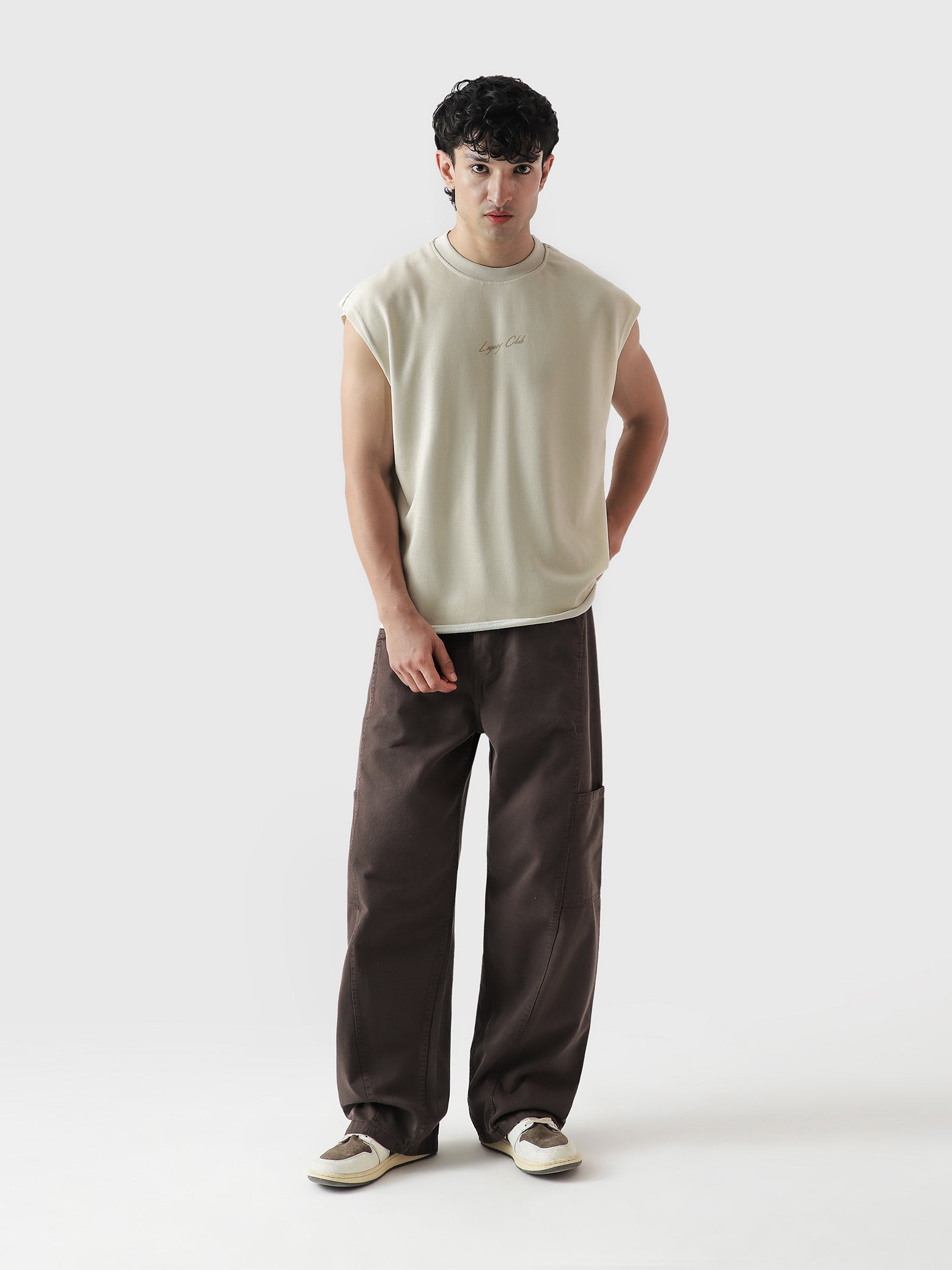 Legacy Club Sando female model lifestyle shot beige sleeveless streetwear Pakistan – GROOVY