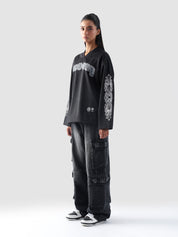 Front view of female model wearing GROOVY’s black full sleeves Chrome Hearts-inspired jersey.