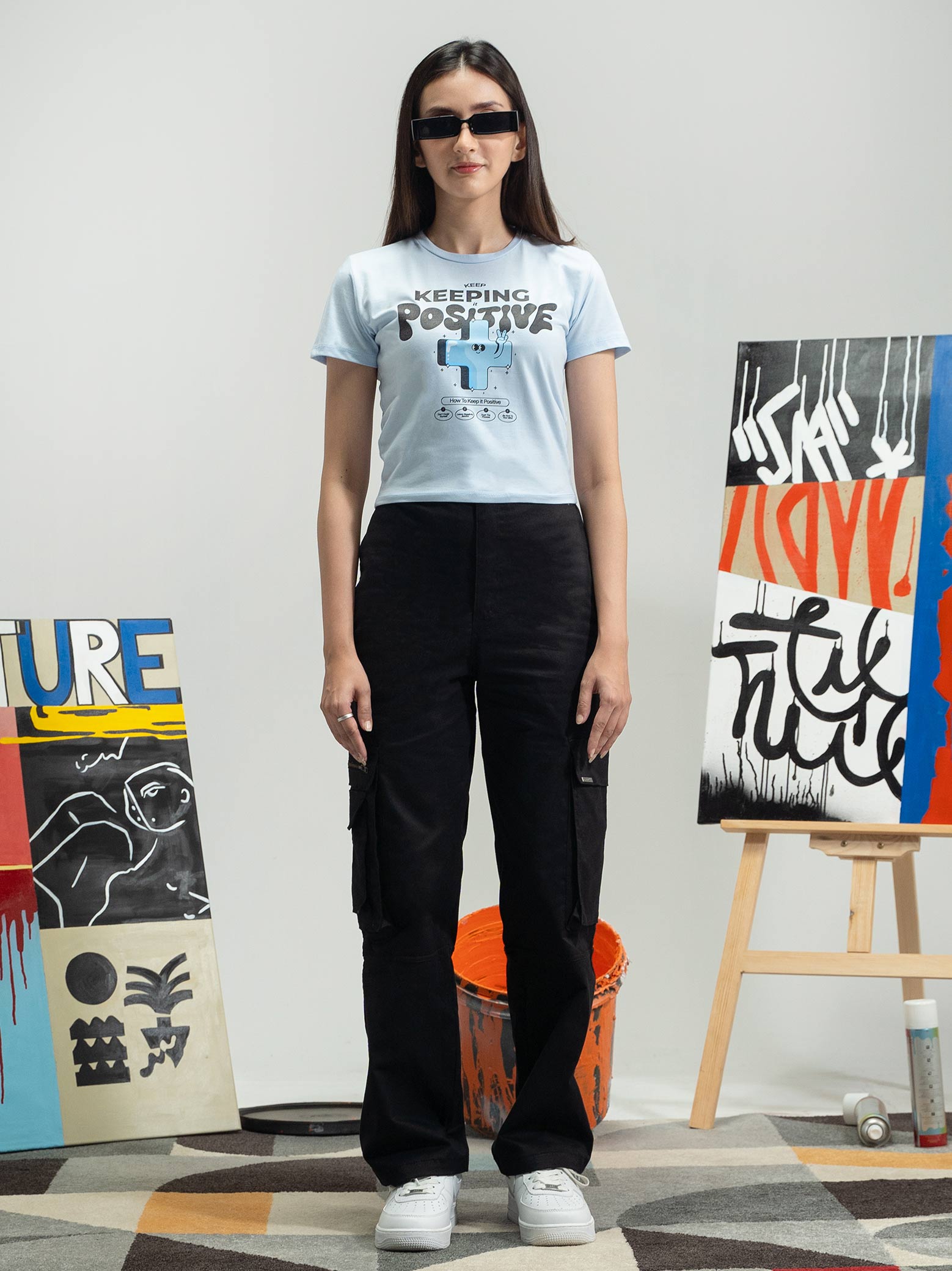 Ice Blue Baby Tee Female Model Front View – Keep Keeping It Positive – GROOVY Pakistan
