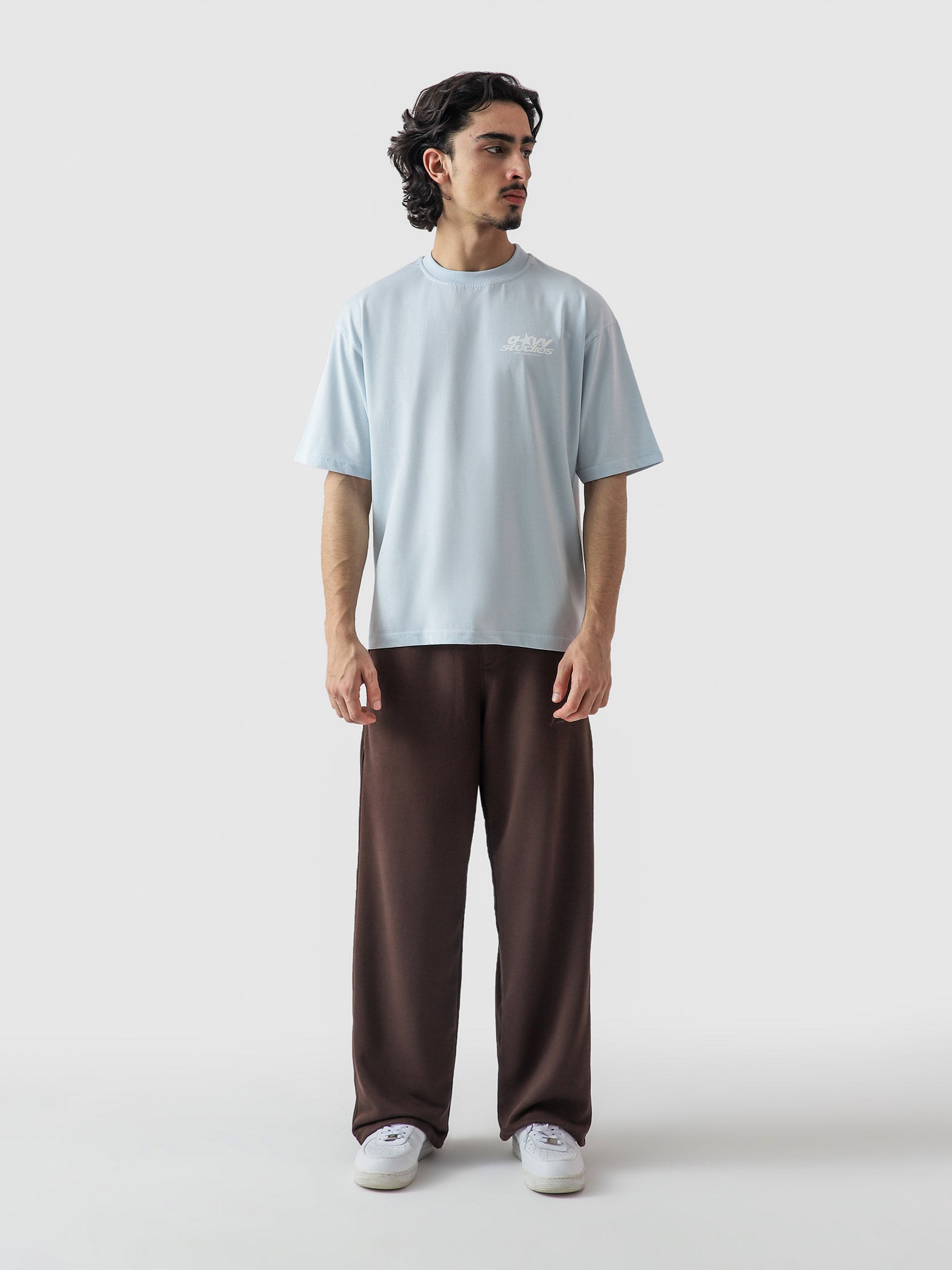 Heart Ashtray frost blue tee male model seated lifestyle Pakistan – GROOVY