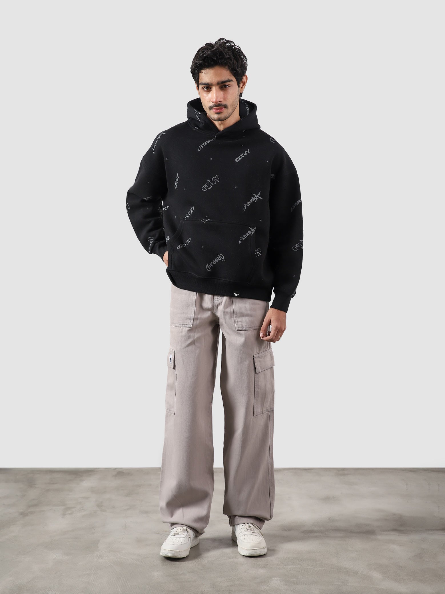 The Initial Hoodie male model full body front view allover initial graphic Pakistan – GROOVY