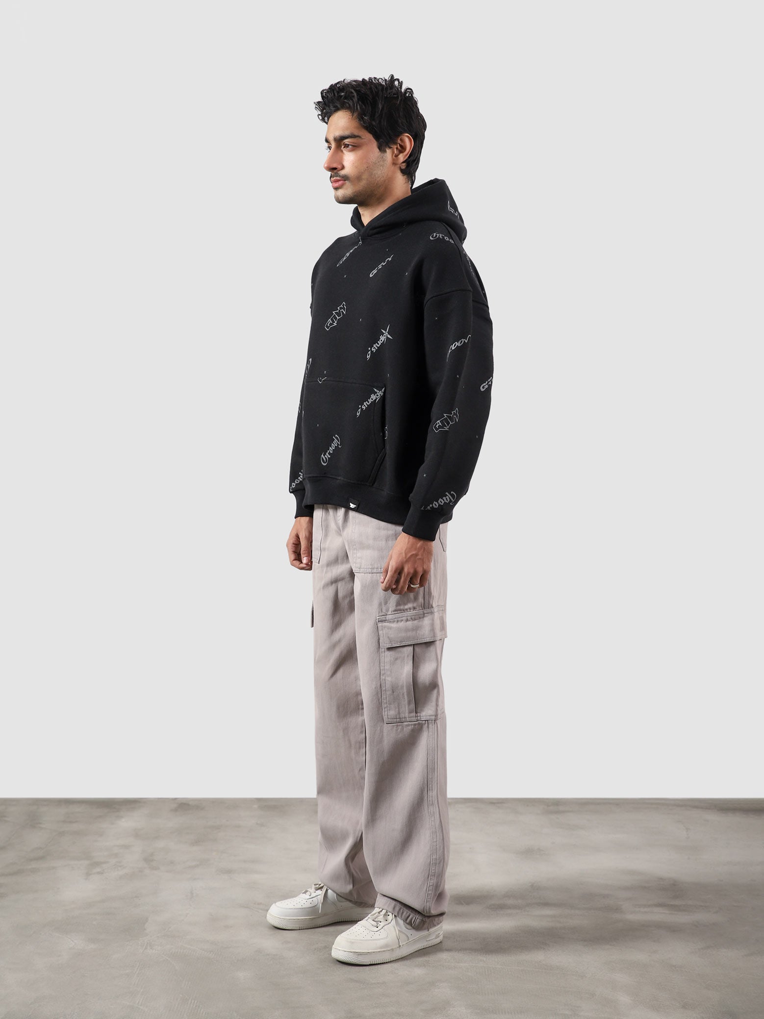 The Initial Hoodie male model back view allover initial graphic Pakistan – GROOVY