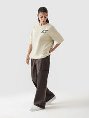 Naruto Uzumaki beige oversized tee male model full body front view Hidden Leaf Pakistan – GROOVY