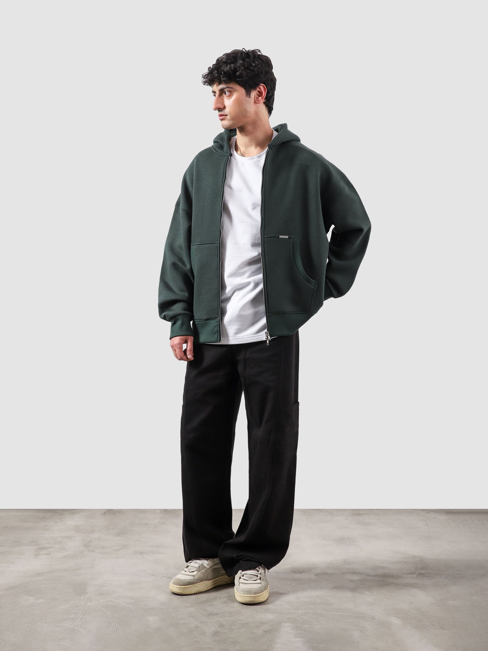 Racing green essential zipper hoodie male model back view relaxed fit Pakistan – GROOVY