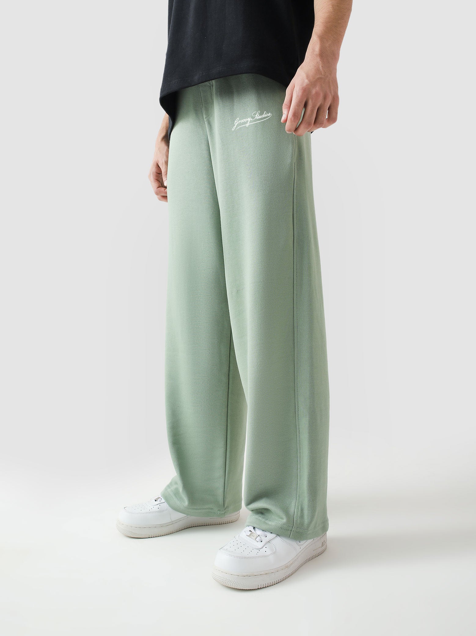 Sage green baggy trousers male model back view relaxed fit Pakistan – GROOVY