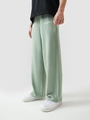 Sage green baggy trousers male model back view relaxed fit Pakistan – GROOVY