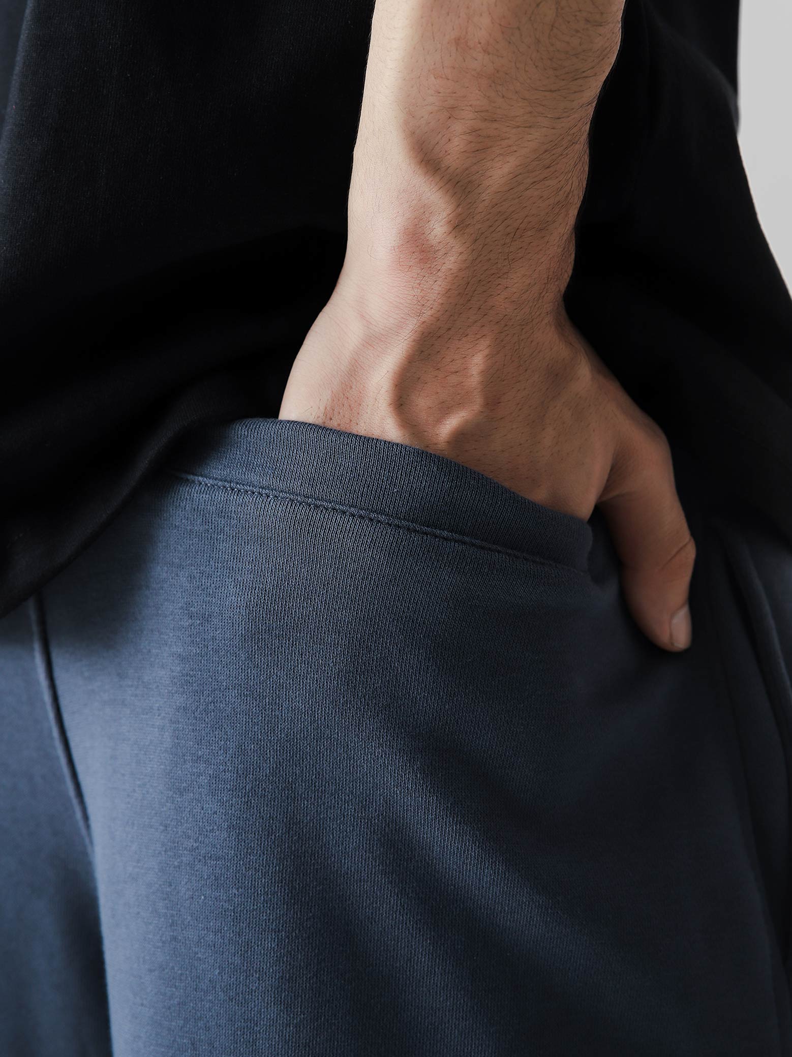 Slate blue baggy trousers male model back view relaxed fit Pakistan – GROOVY