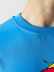 MONEY LOVES ENERGY tee male model side angle electric blue oversized Pakistan – GROOVY