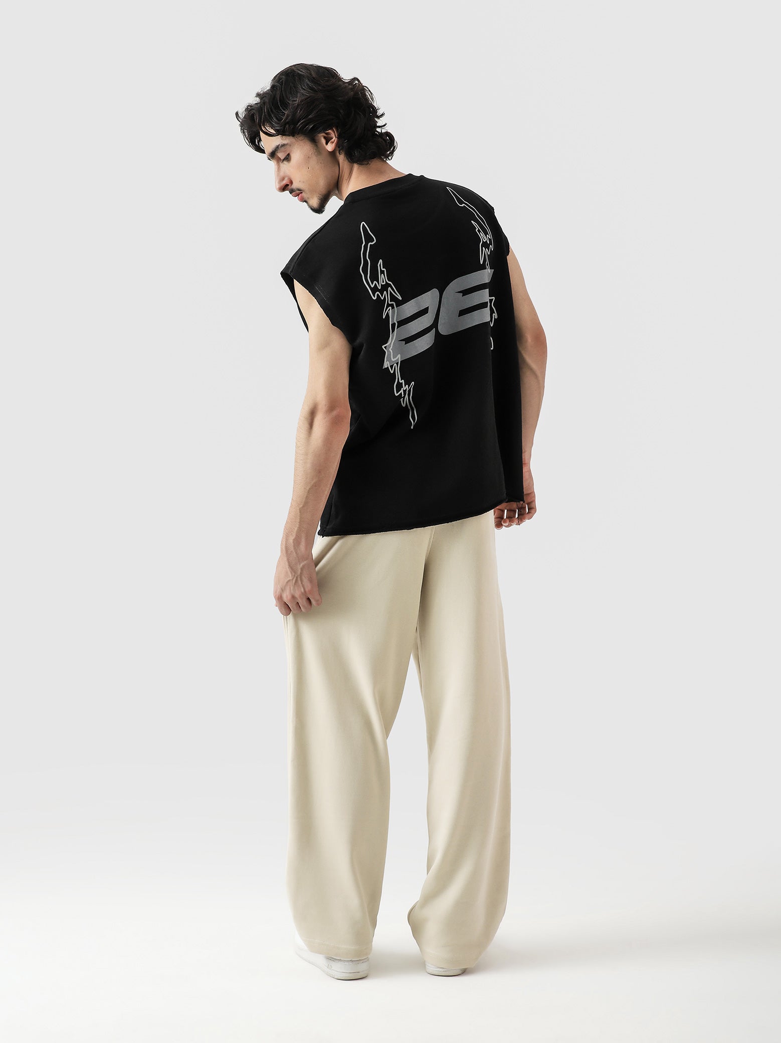 Young and Turnt Sando male model side view black graphic streetwear Pakistan – GROOVY