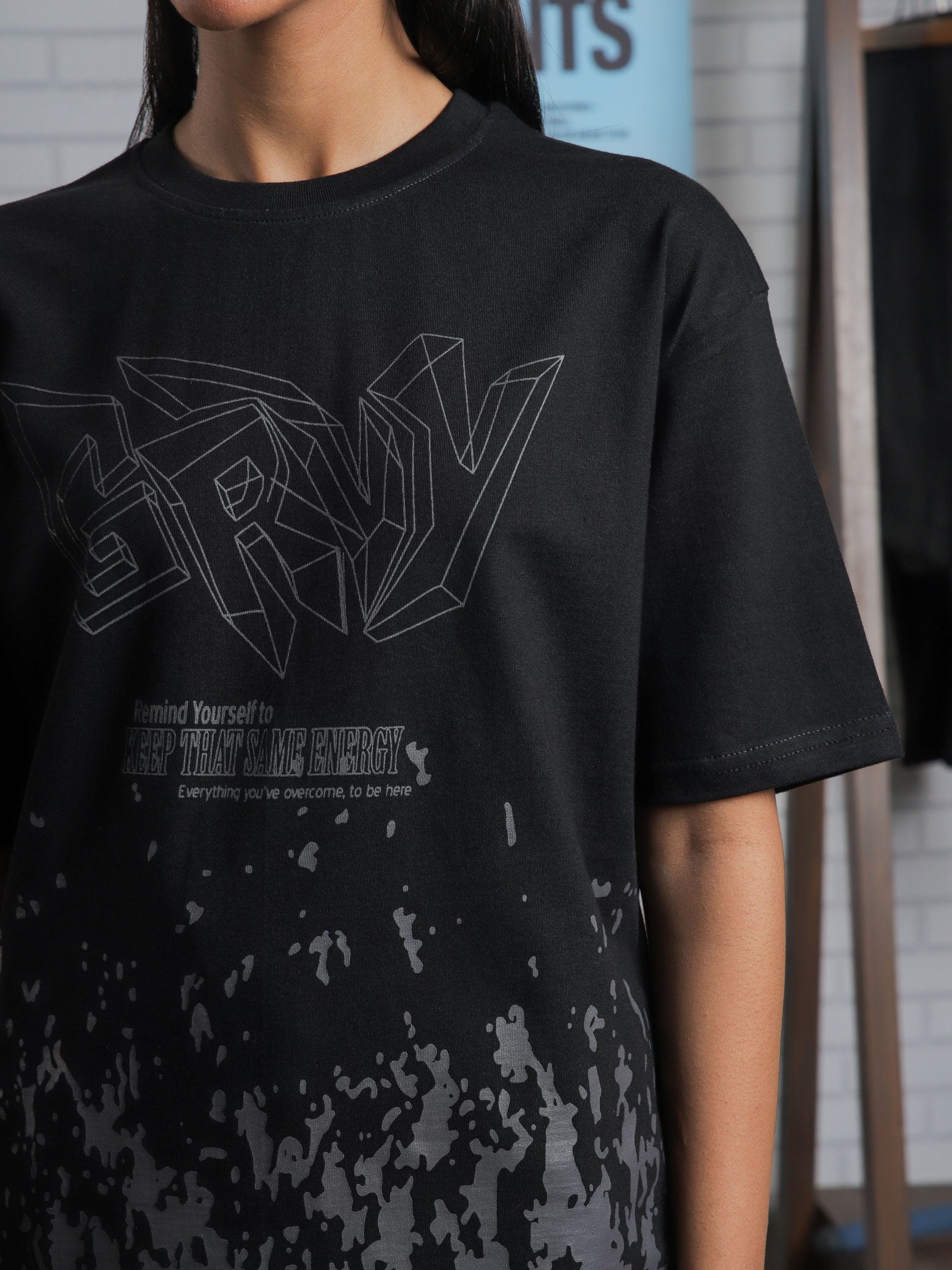 Close-up of GRVY front graphic and motivational quote “Keep That Same Energy” on black heavy-weight streetwear t-shirt.