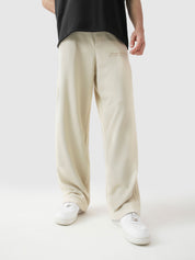 Cream baggy trousers front view male model relaxed fit streetwear Pakistan – GROOVY