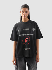 Close-up of "GROOVY Energy" t-shirt featuring silver and red graphic print and slogan “The Best is Yet to Come” – urban streetwear detail.