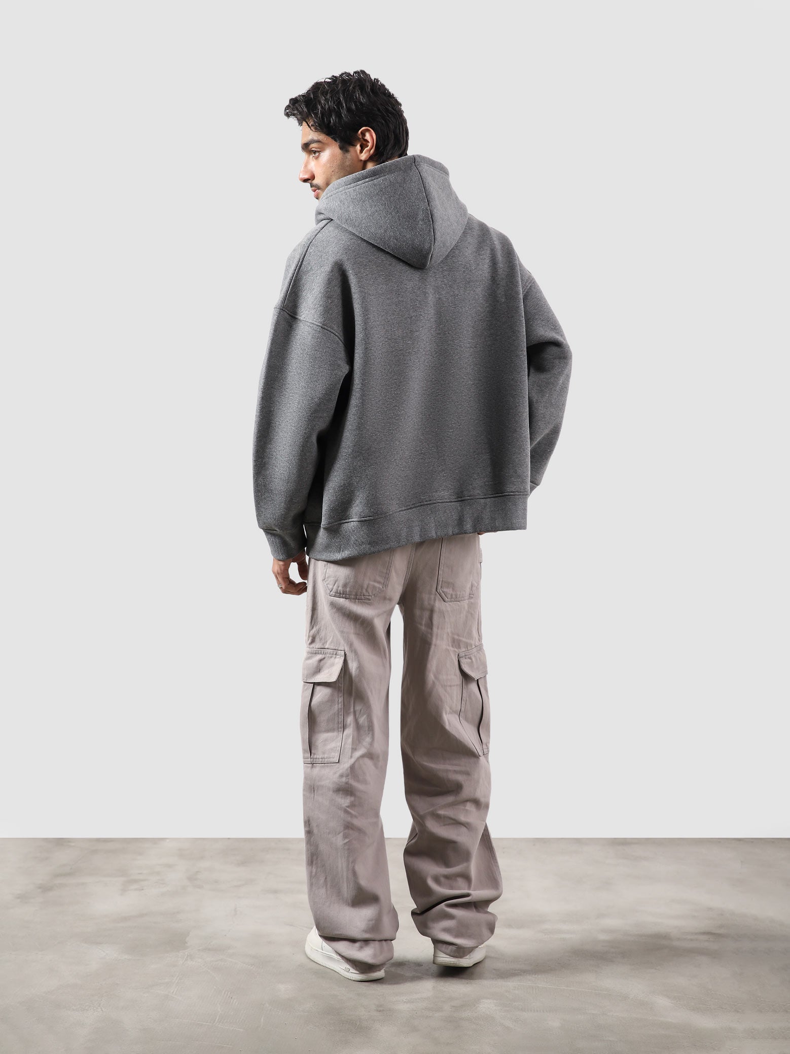 Dark heather grey essential zipper hoodie male model side view full body Pakistan – GROOVY