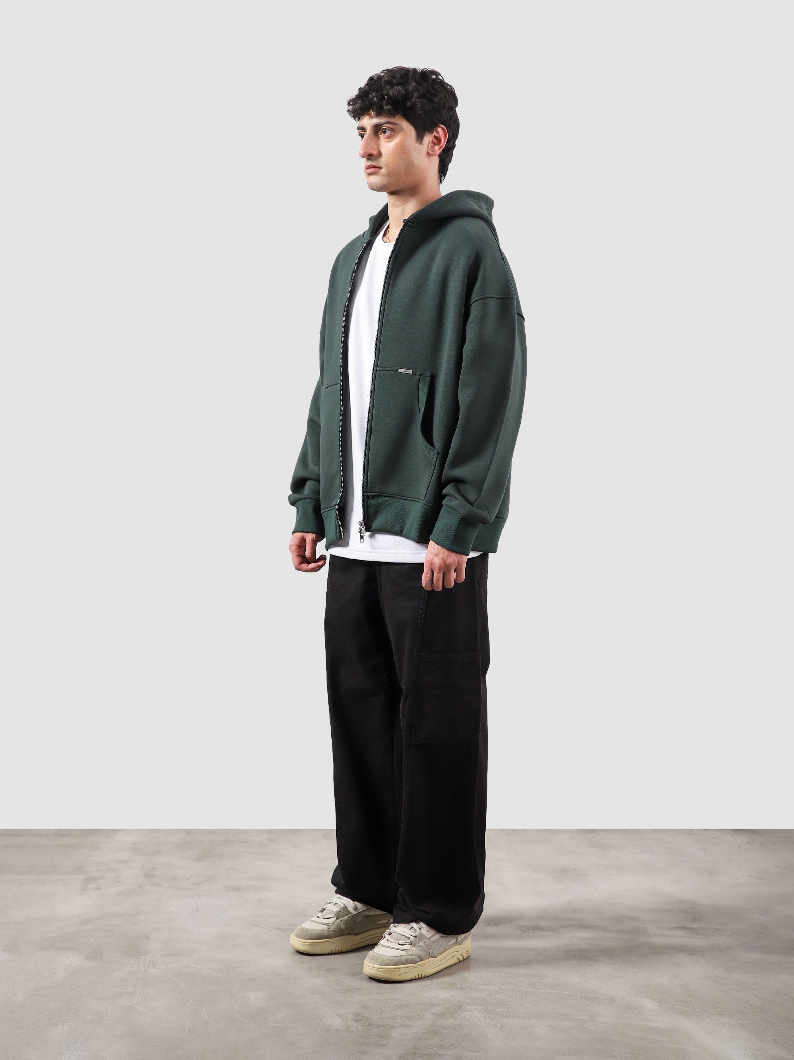 Racing green essential zipper hoodie male model side view full body Pakistan – GROOVY