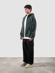 Racing green essential zipper hoodie male model side view full body Pakistan – GROOVY