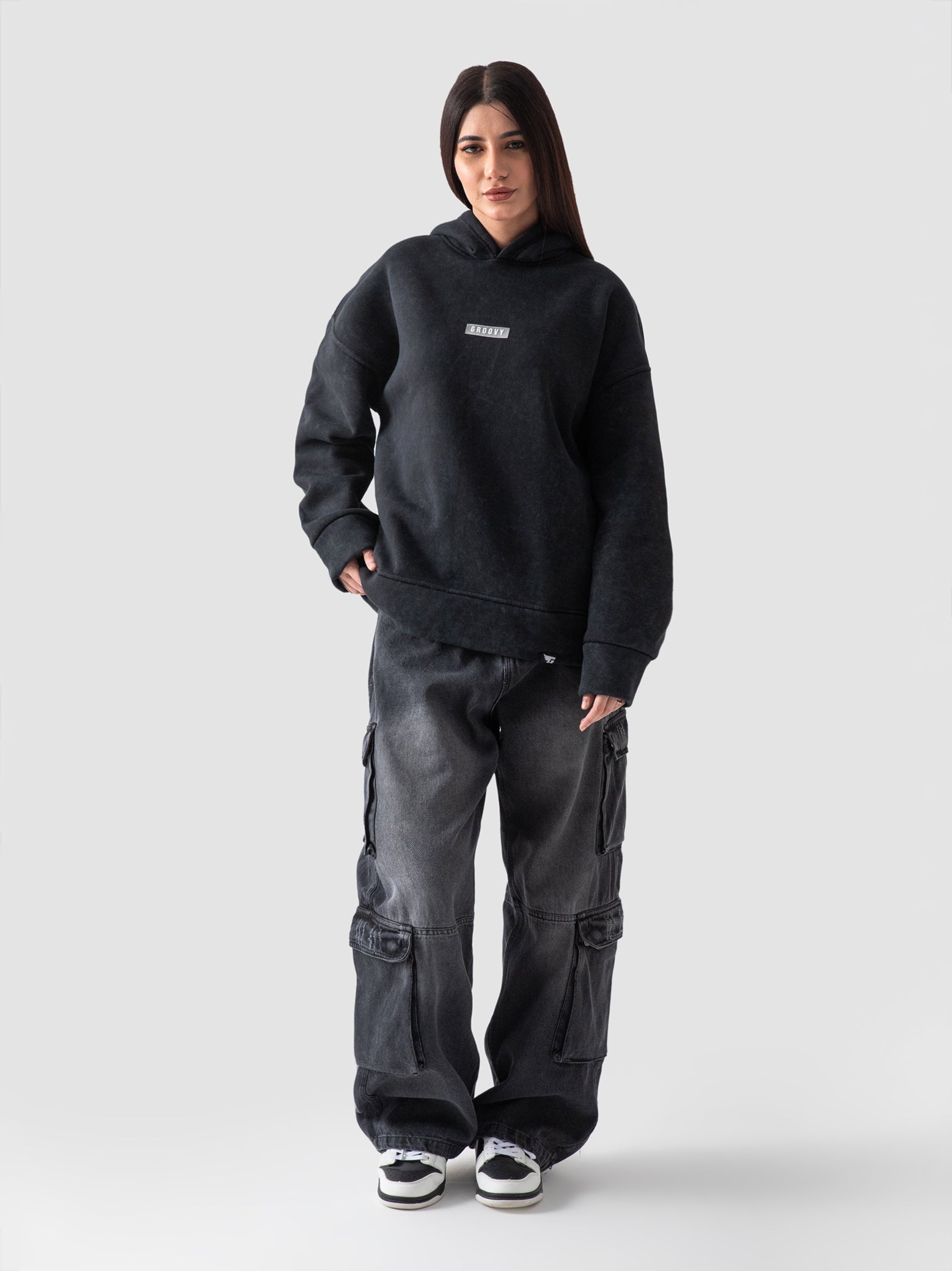 Washed black hoodie female model front view oversized Pakistan – GROOVY