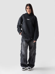 Washed black hoodie female model front view oversized Pakistan – GROOVY