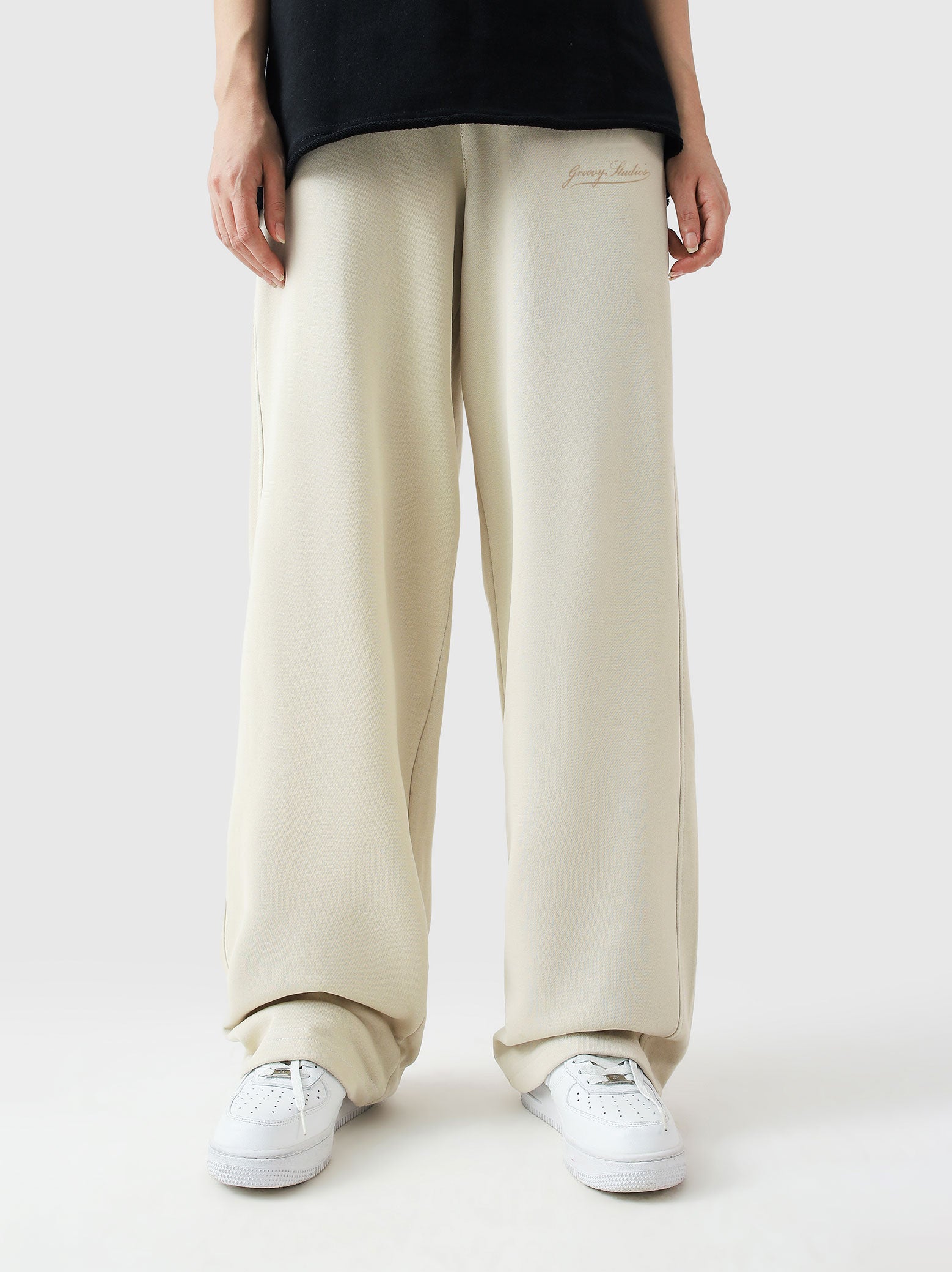 Cream baggy trousers female model back view relaxed fit Pakistan – GROOVY