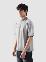 Front-facing view of the Oil Fade Blank t-shirt styled on a male model, highlighting the garment’s structured drop shoulder, relaxed silhouette, and signature faded wash.
