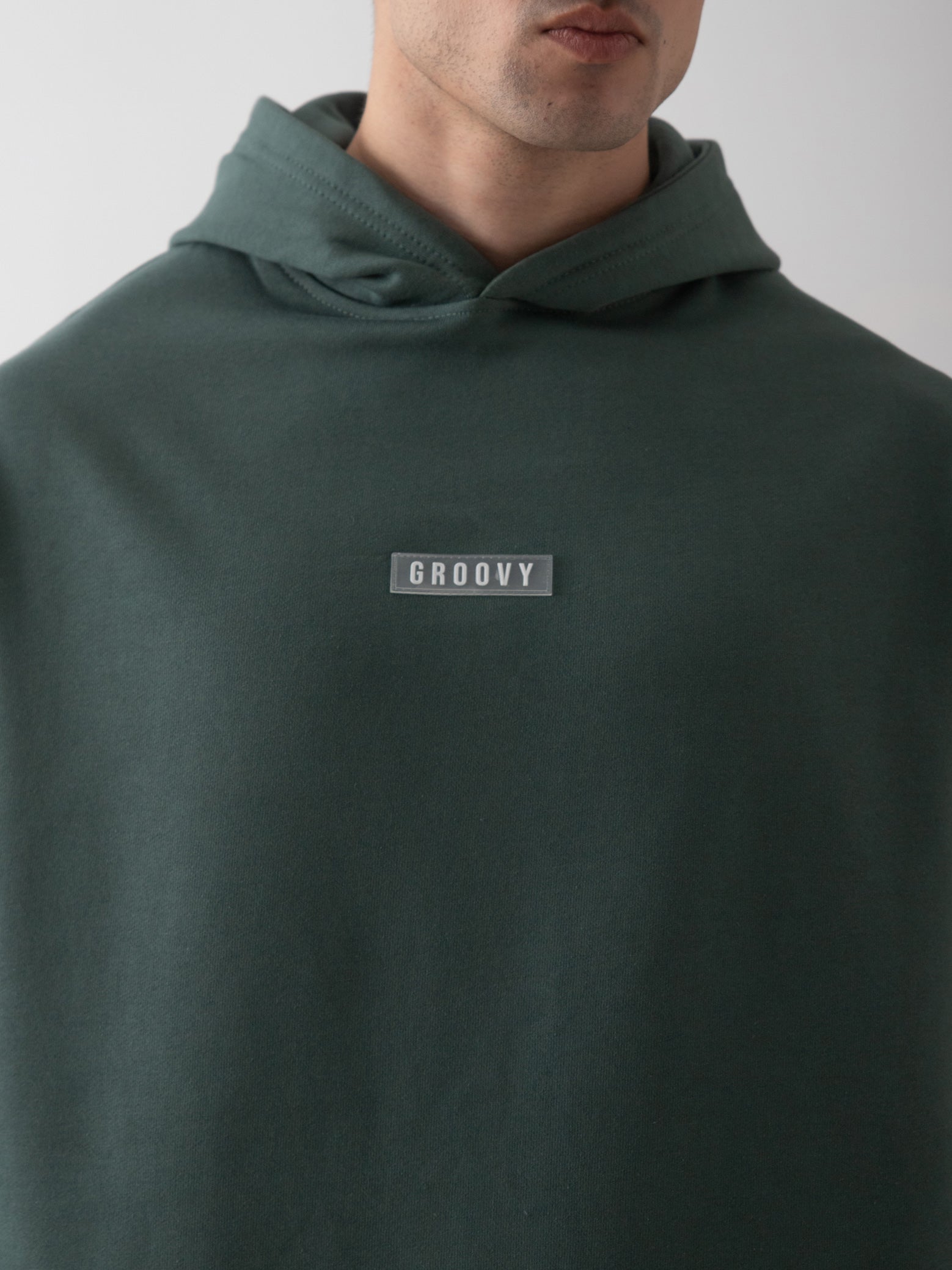 Hunter green oversized hoodie detail closeup kangaroo pocket front Pakistan – GROOVY