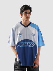 Man wearing oversized blue and white sublimation jersey with racing-inspired graphics – streetwear top by Groovy Culture Pakistan