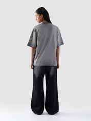 Dept of Visionaries tee male model seated lifestyle shot Pakistan – GROOVY
