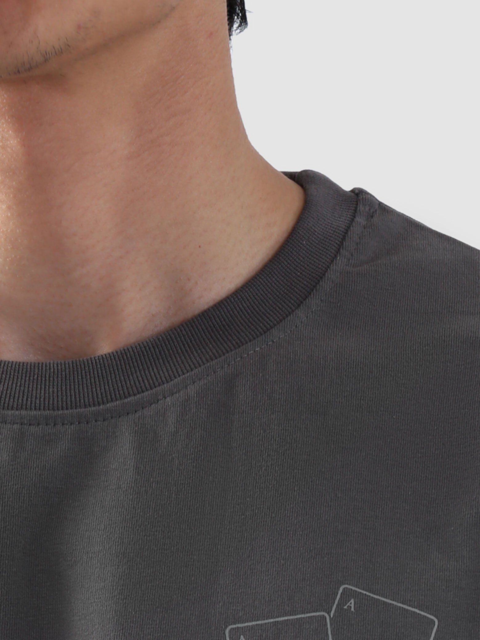 Close-up of ribbed neckline on stone grey oversized t-shirt from Groovy Pakistan – premium stitching detail and relaxed collar design