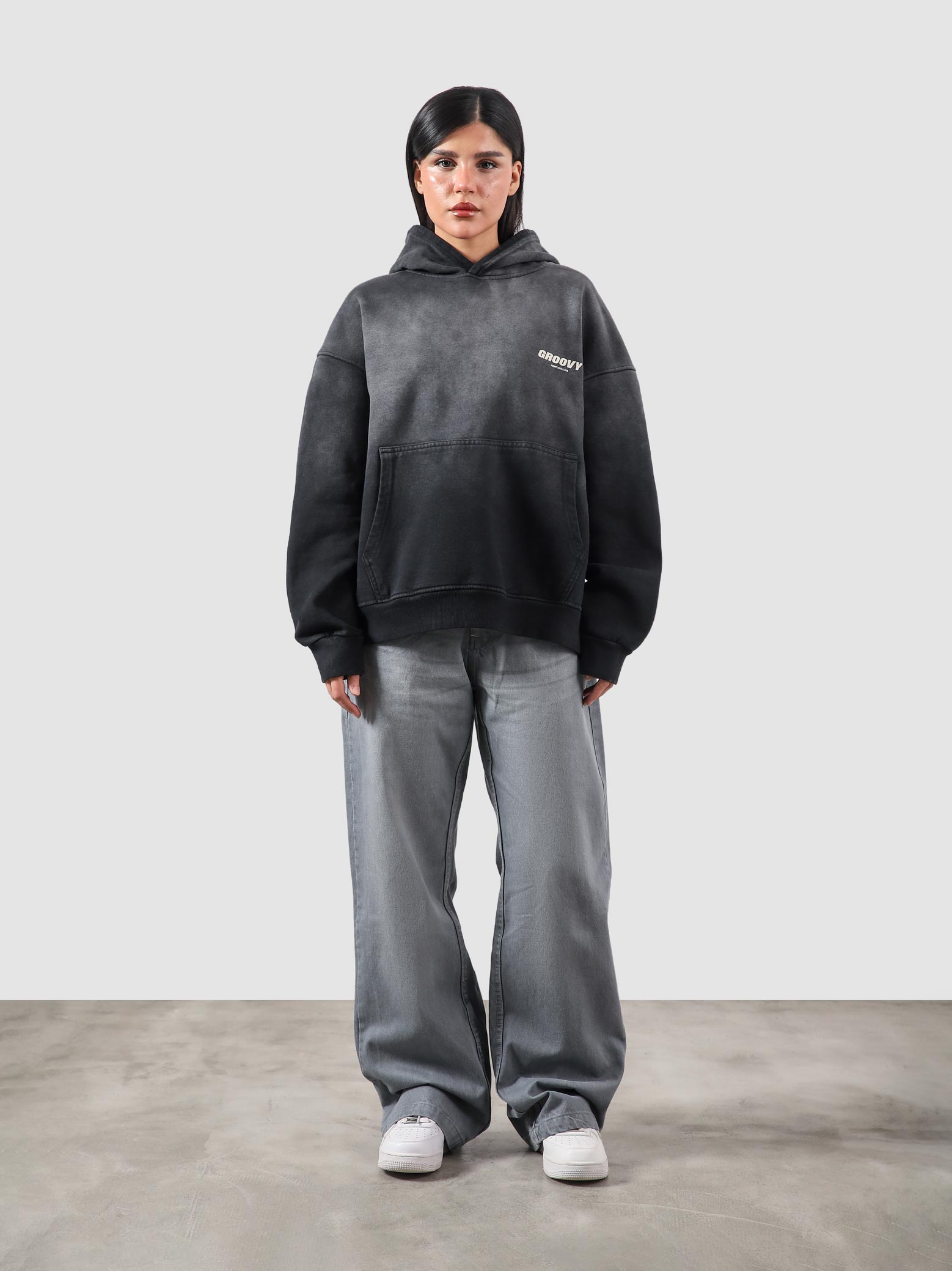 Fade washed hoodie male model seated half body lifestyle shot Pakistan – GROOVY