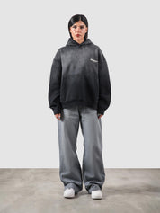 Fade washed hoodie male model seated half body lifestyle shot Pakistan – GROOVY