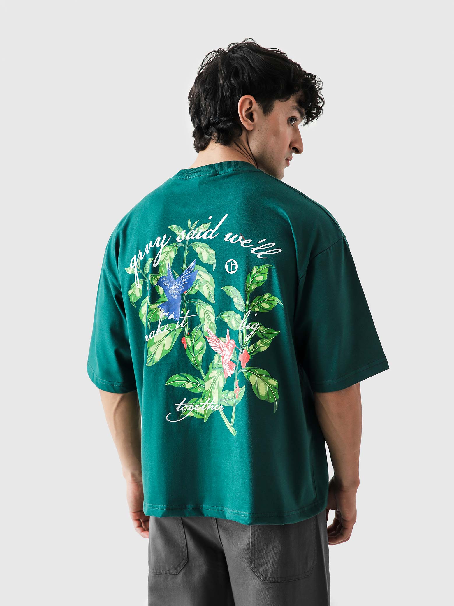 Green Hummingbird tee male model seated lifestyle Pakistan – GROOVY