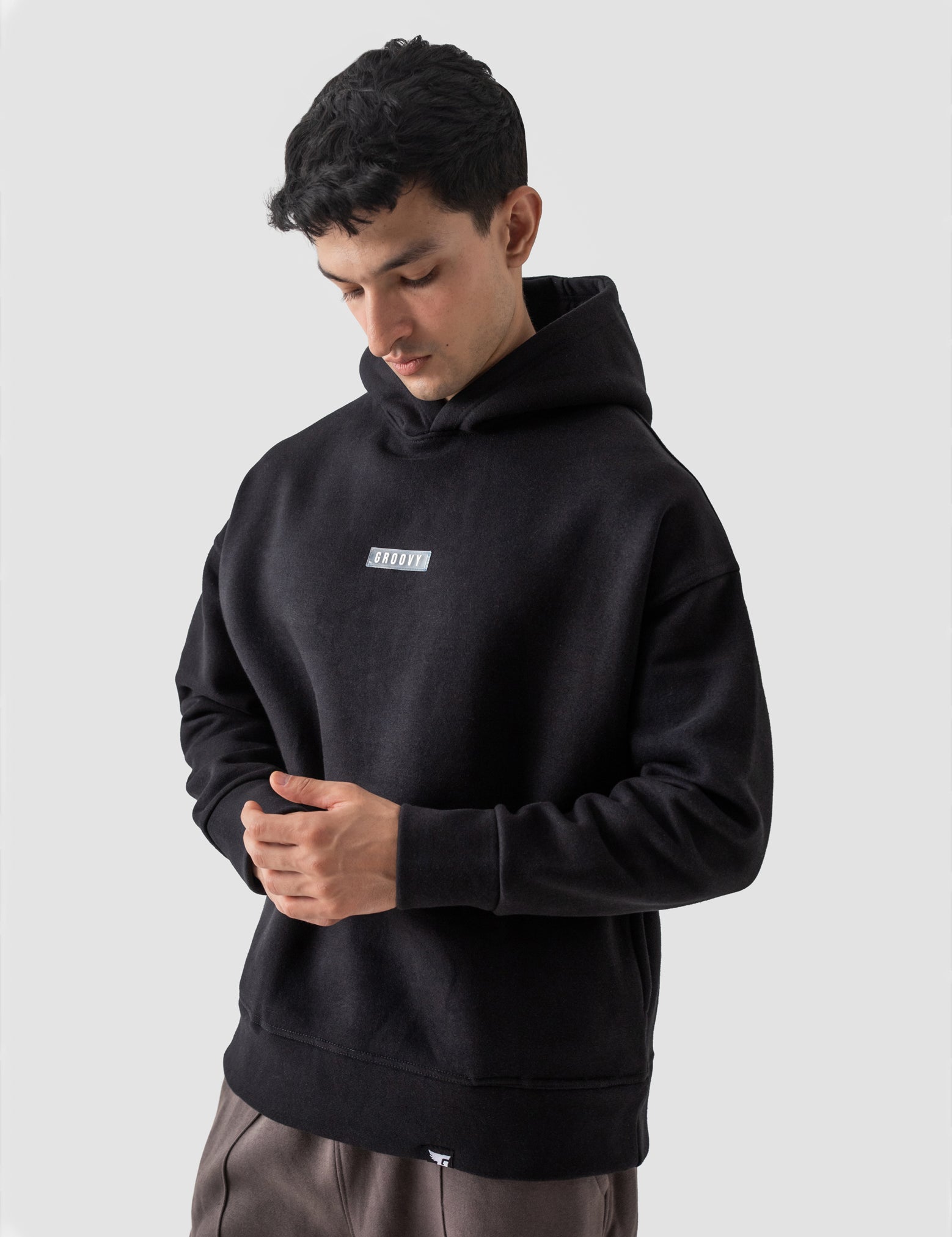 Black oversized hoodie back view relaxed fit Pakistani streetwear – GROOVY