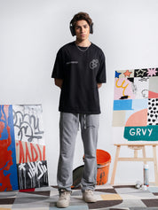 Initial Assembly black graphic tee male model full body front view Pakistan – GROOVY