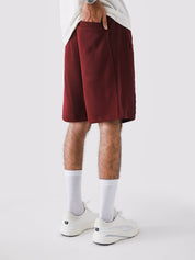 Wine Red Aim Shorts on model, relaxed-fit men's gym and casual shorts by GROOVY Pakistan
