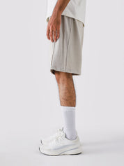 Ash Grey Aim Shorts on model, relaxed-fit men's gym and casual shorts by GROOVY Pakistan
