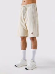 Cream Aim Shorts on model, relaxed-fit men's gym and casual shorts by GROOVY Pakistan