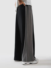 Side profile of black panelled terry sweatpants - GROOVY Pakistan