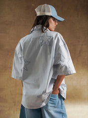 Reverse appliqué stars across the back of a grey denim shirt - GROOVY Pakistan
