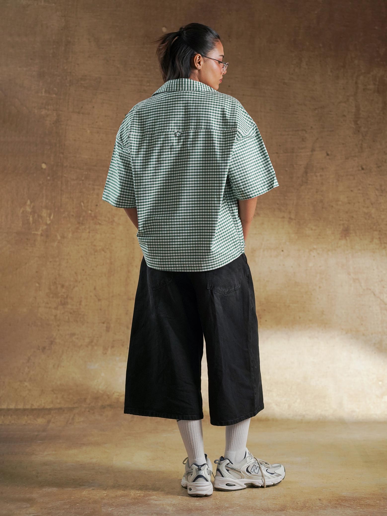 Female model wearing green gingham oversized shirt - GROOVY Pakistan