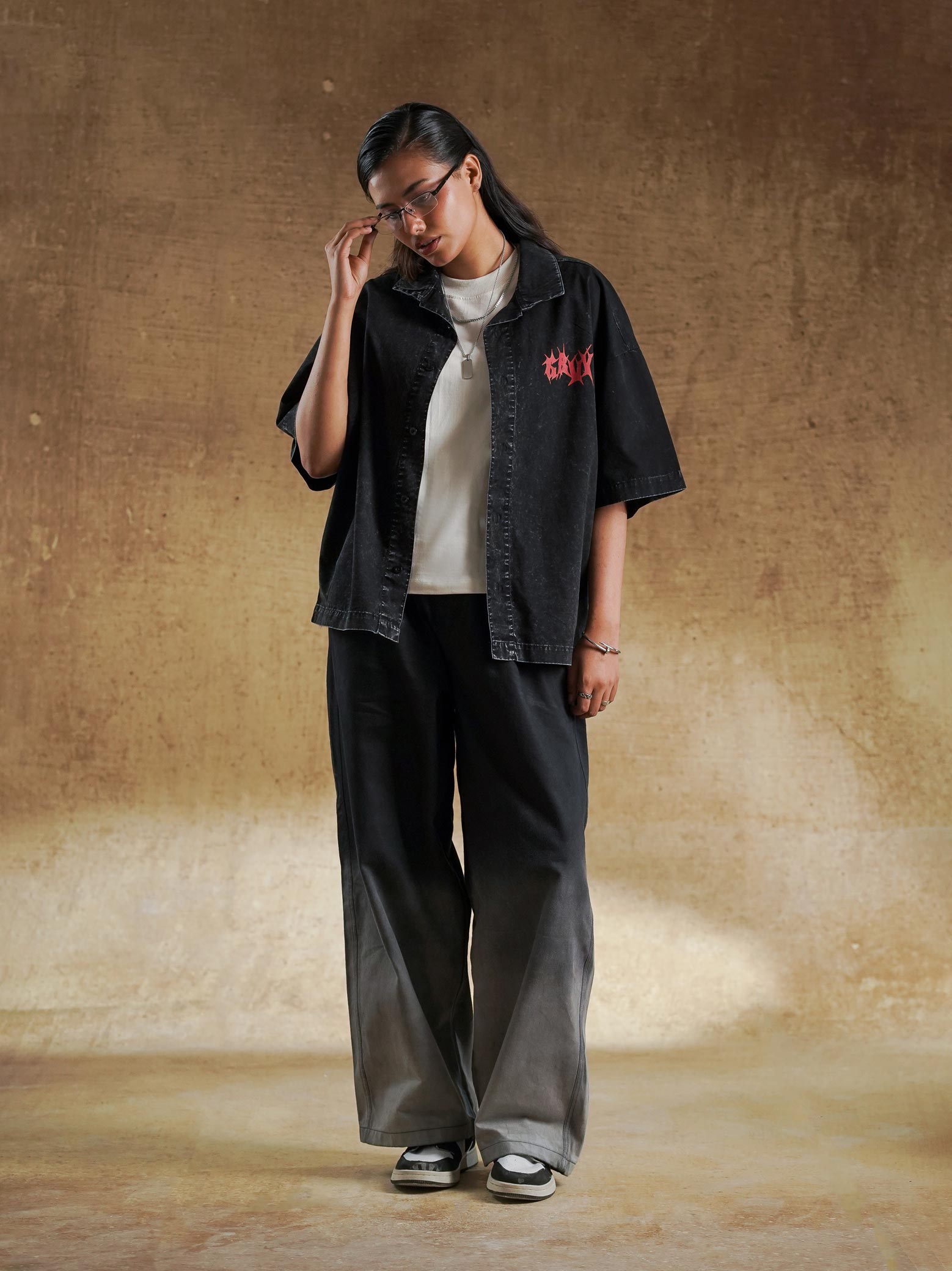 Hem and side seam of black acid wash shirt - GROOVY Pakistan