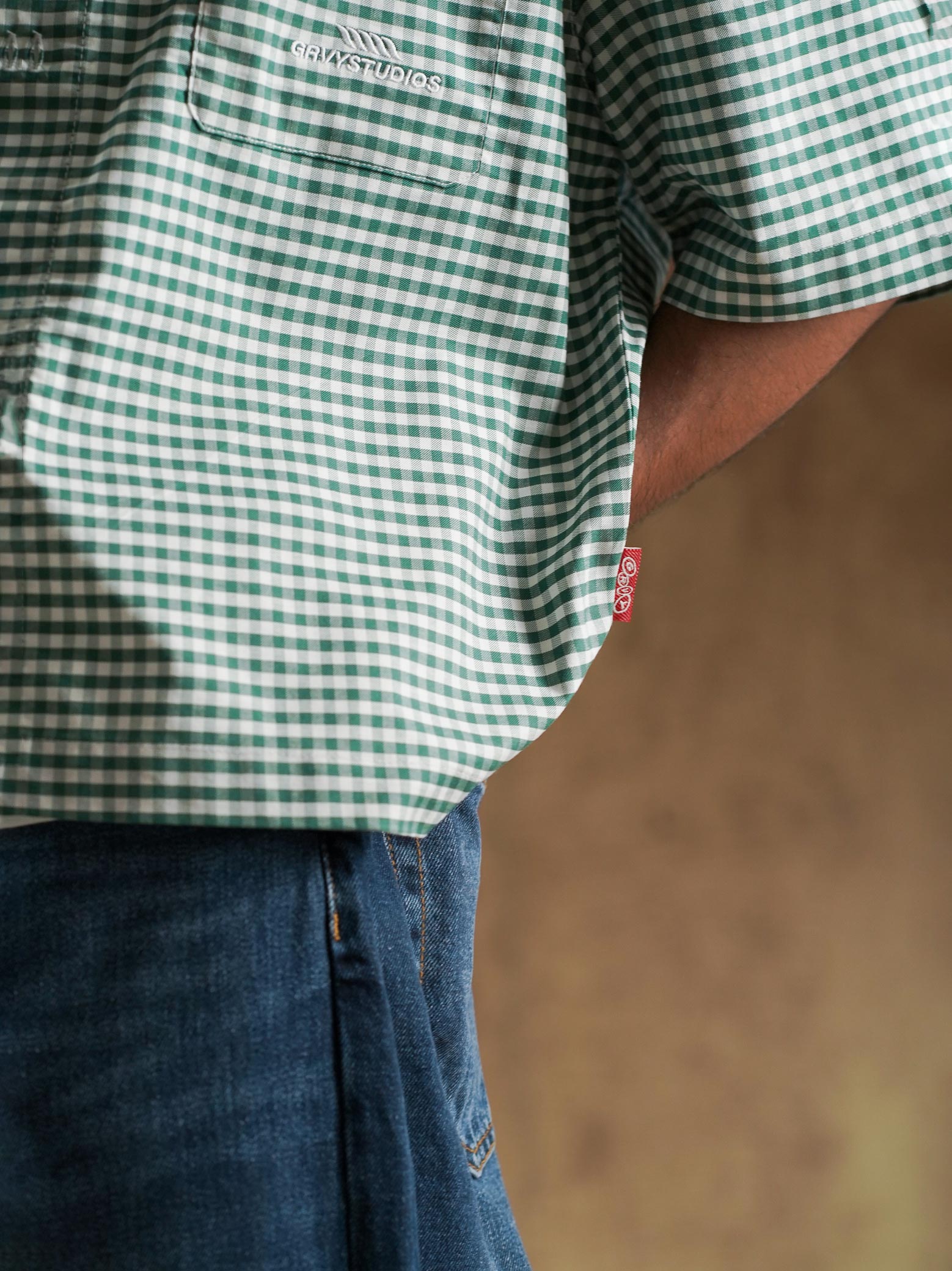 Green check shirt worn open over a cream tee - GROOVY Pakistan
