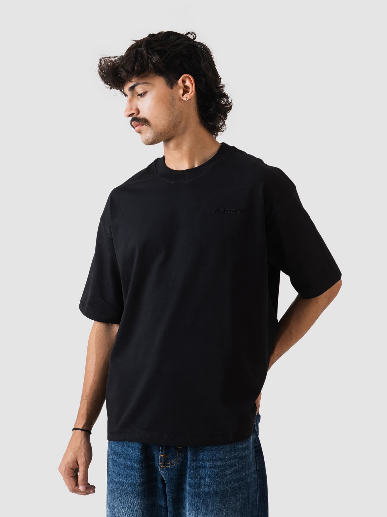 black oversized t-shirt from GROOVY, embroidered logo, made in Pakistan